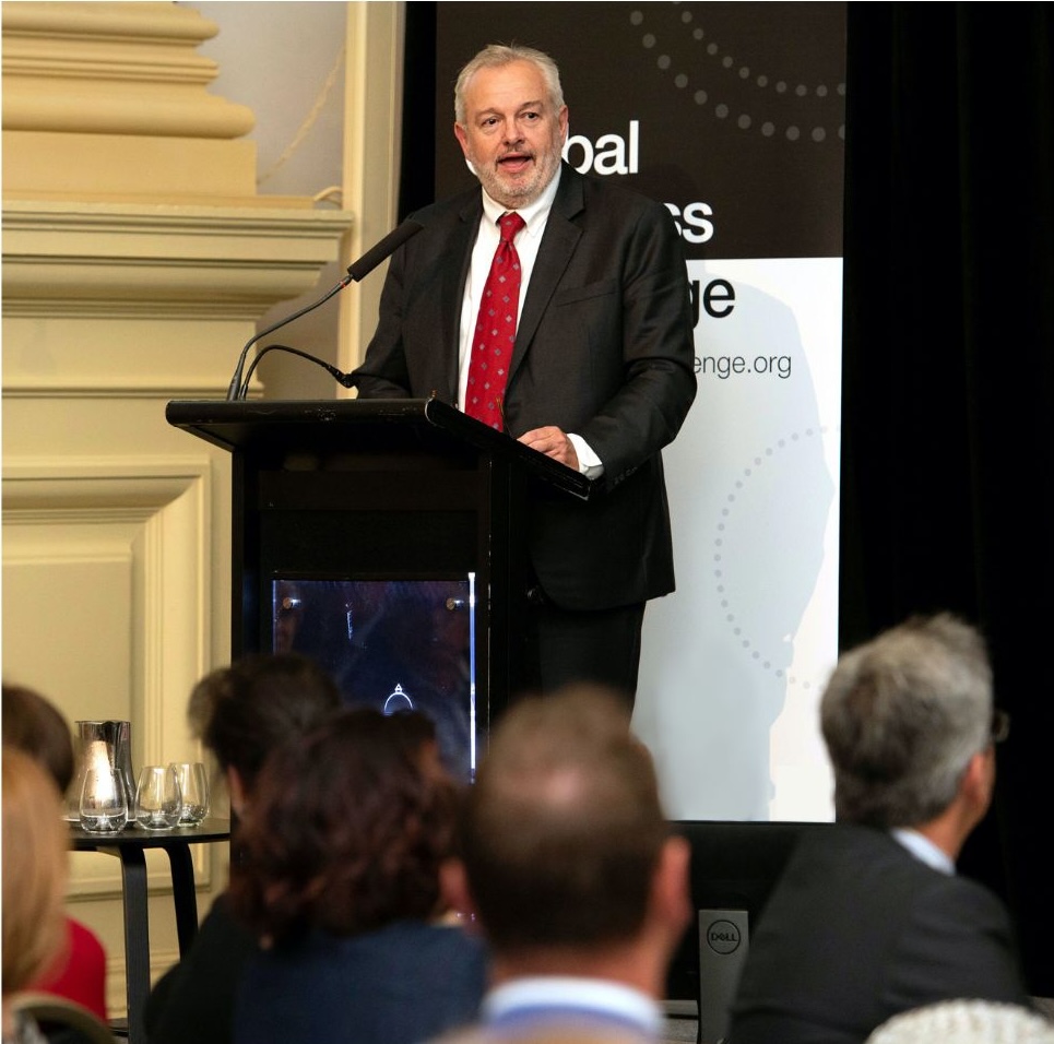 Dr Peter Beven speaking at a podium